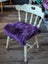 Grape purple merino sheepskin chair pad with heart cutout, meeting strict European standards
