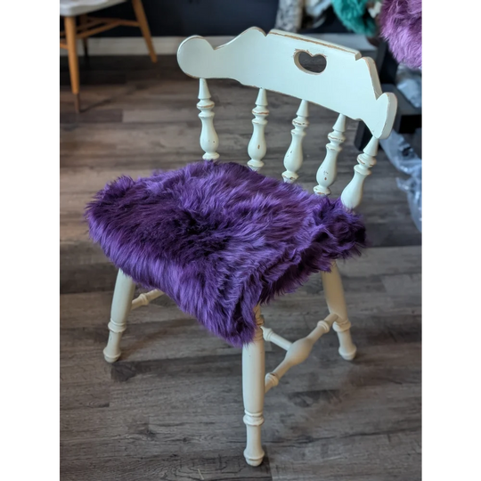 Grape purple merino sheepskin chair pad with heart cutout, meeting strict European standards