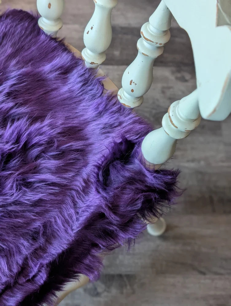 Grape purple sheepskin chair pad with faux fur, mint legs, white pom-poms