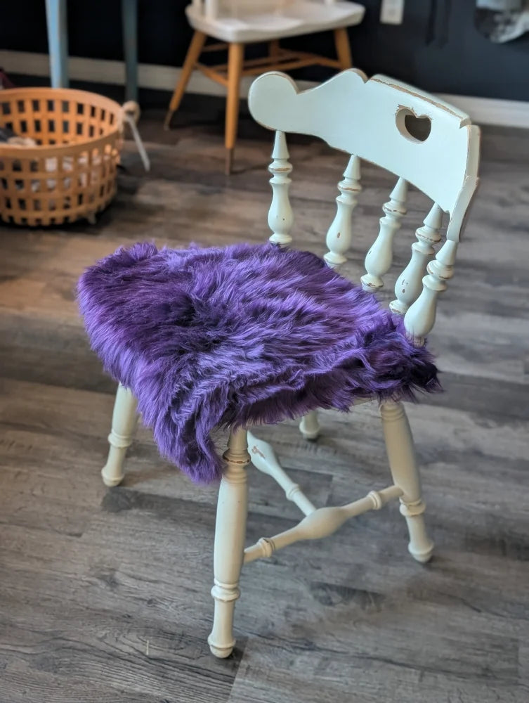 Grape purple merino sheepskin chair pad with heart cutout, meets strict European standards
