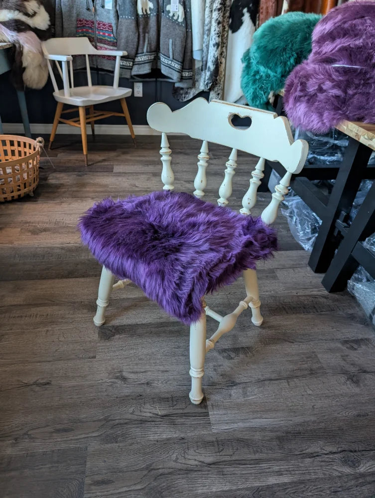 Grape purple merino sheepskin chair pad with white wooden legs
