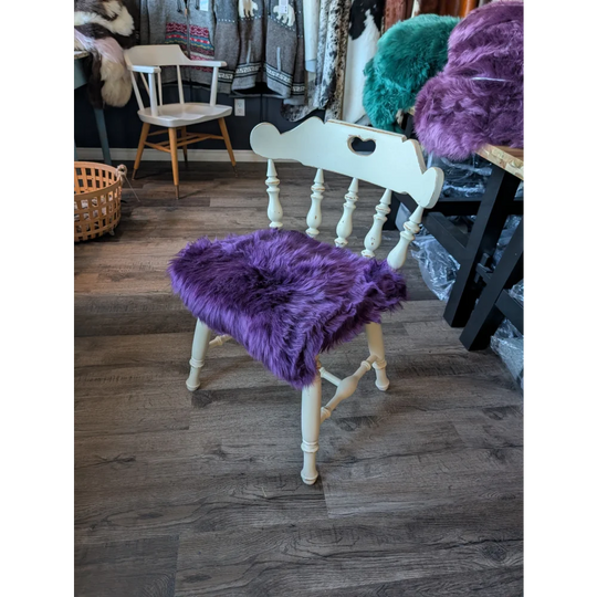 Grape purple merino sheepskin chair pad with white wooden legs