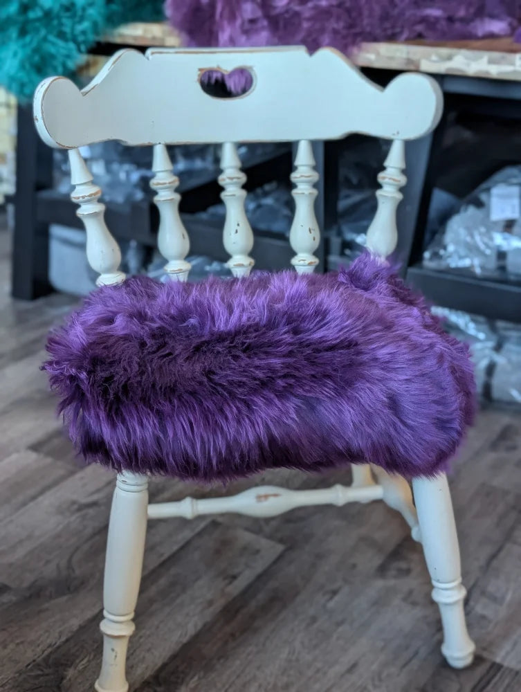 Grape purple merino sheepskin chair pad on white wooden frame, European standards
