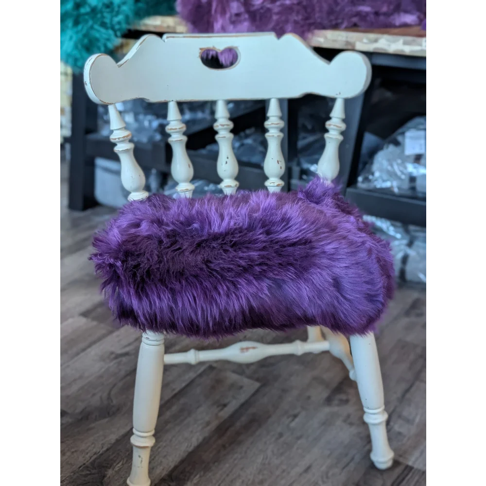 Grape purple merino sheepskin chair pad on white wooden frame, European standards