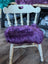 Grape purple merino sheepskin chair pad on white wooden frame, European standards