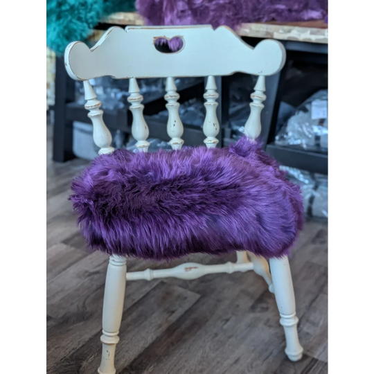 Grape purple merino sheepskin chair pad on white wooden frame, European standards