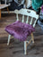 Plum purple merino sheepskin chair pad with lavender faux fur on white wooden spindle frame