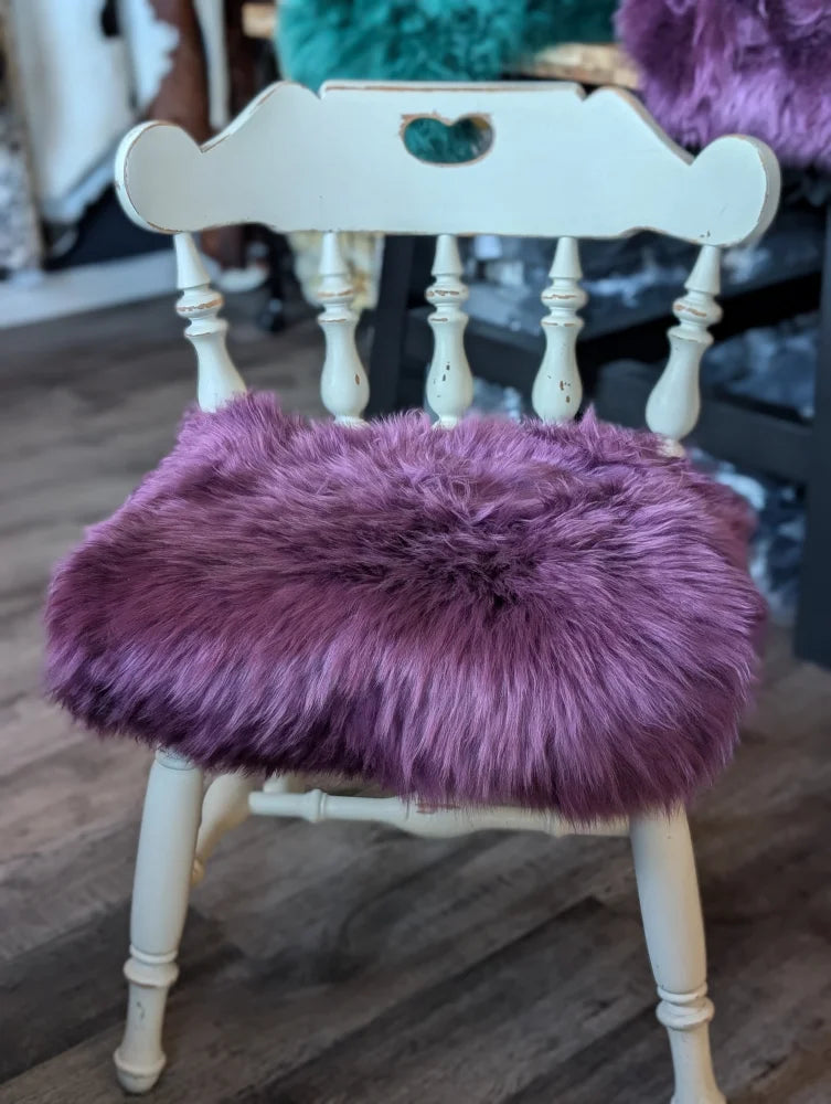 Plum purple merino sheepskin chair pad with lavender faux fur and white wooden frame