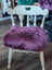 Plum purple merino sheepskin chair pad with lavender faux fur and white wooden frame