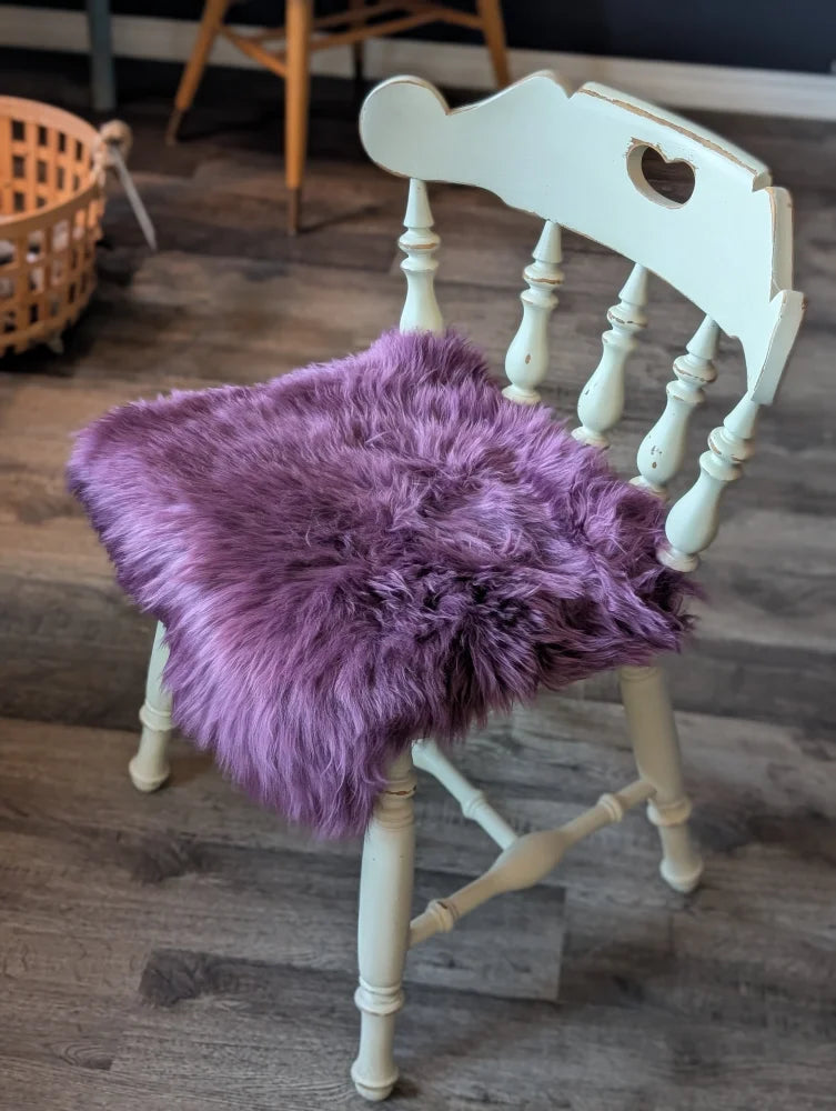 Plum purple merino sheepskin chair pad with lavender faux fur heart cutout