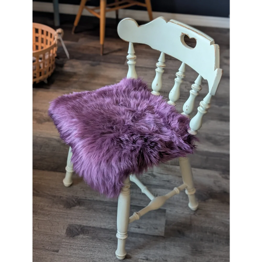 Plum purple merino sheepskin chair pad with lavender faux fur heart cutout
