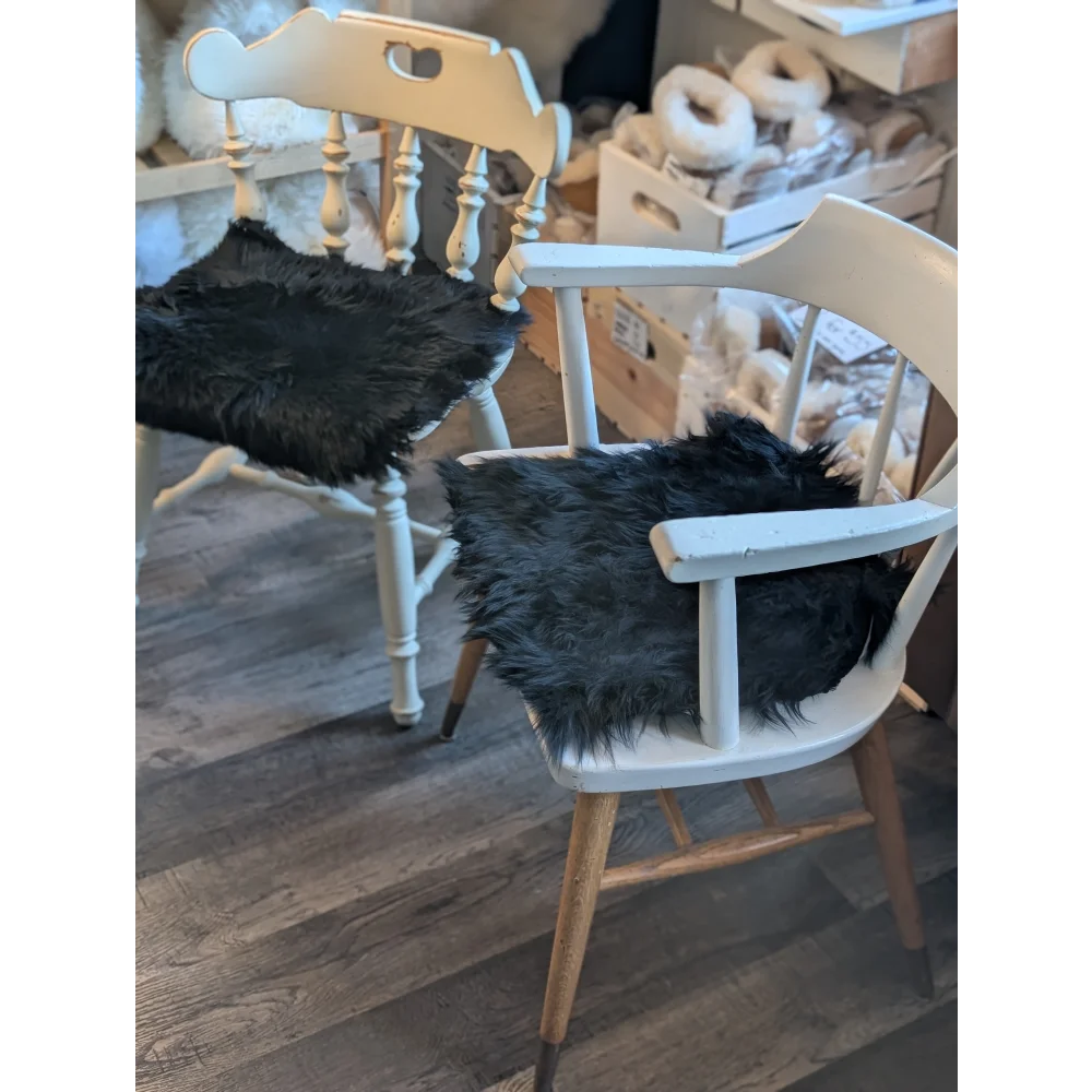 Gorgeous black merino sheepskin chair pad with wooden legs, modern design