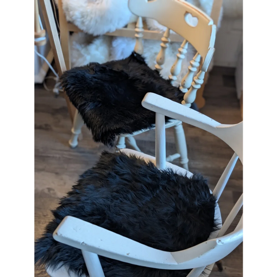 Gorgeous black merino sheepskin chair pad with gold tassels