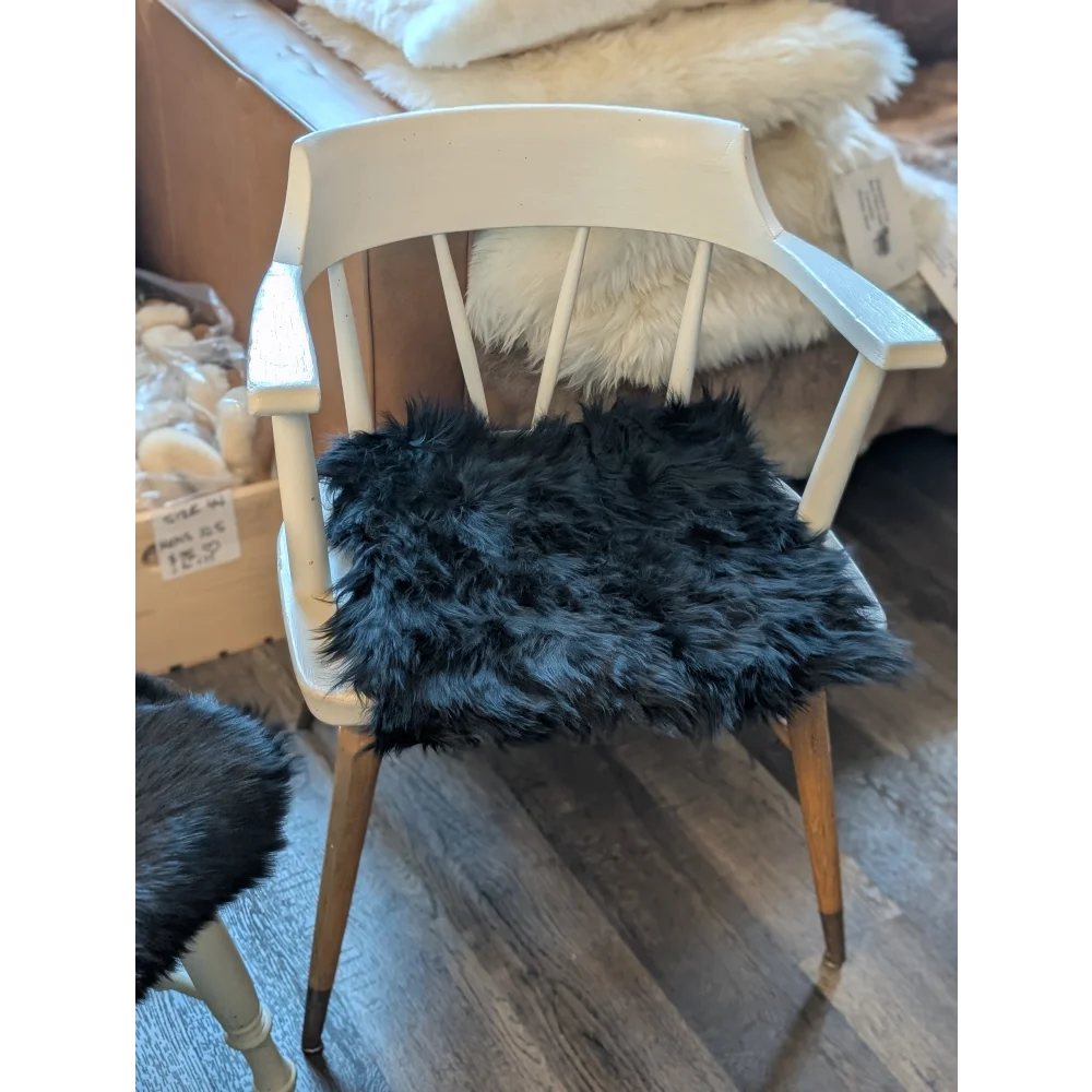 White wooden chair with gorgeous black merino sheepskin pad