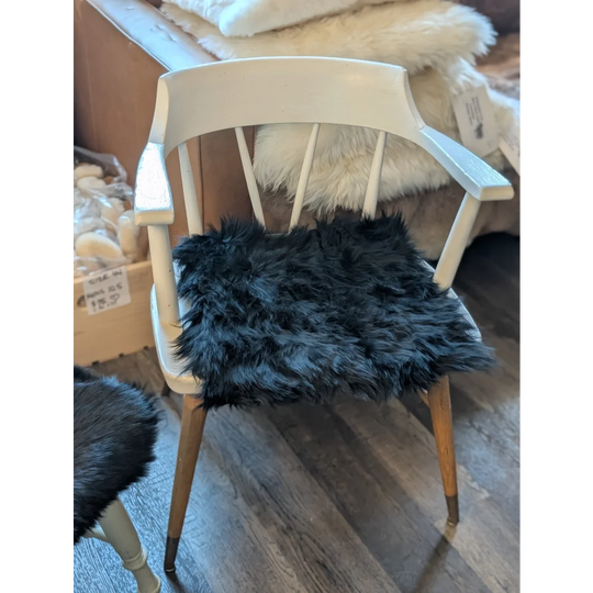 White wooden chair with gorgeous black merino sheepskin pad