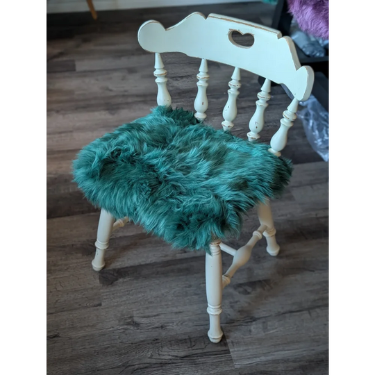 White wooden chair with gorgeous green merino sheepskin pad