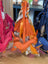 Orange dachshund bag charm with tassel, scarf by Angus Oliver