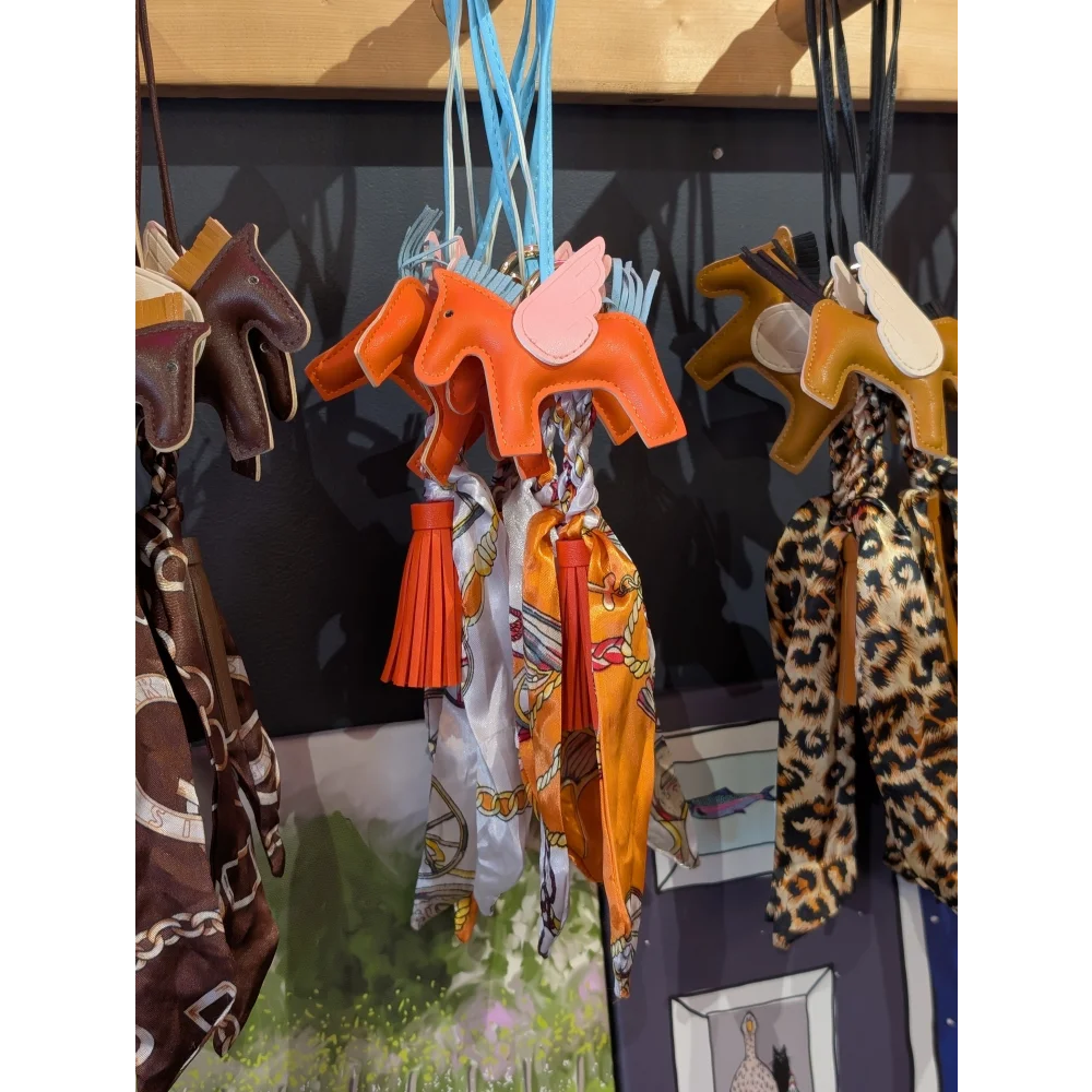 Orange horse bag charm with pink wings, leather and tassel