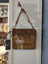 Ornate brown leather hairon bag with embossed floral cowhide flap