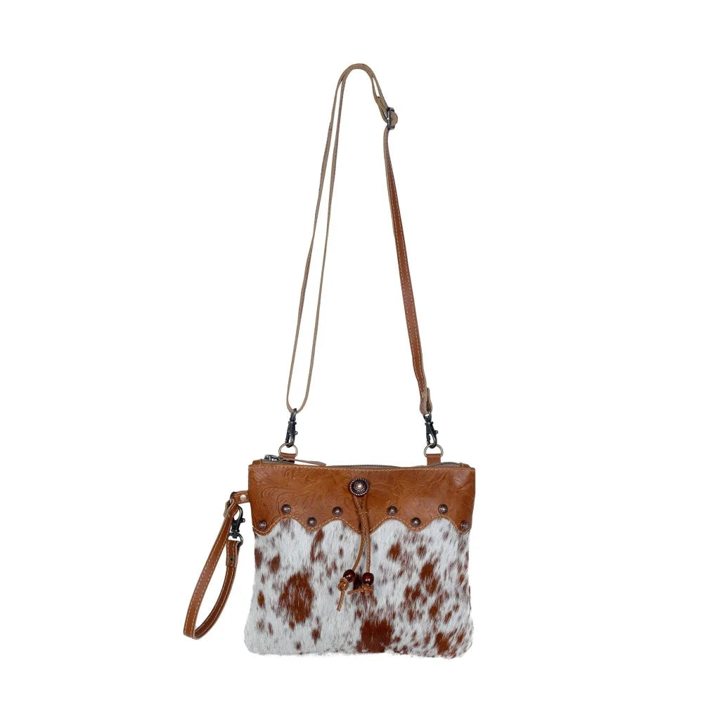 Ornate brown leather hairon bag with cowhide, studs, tan trim