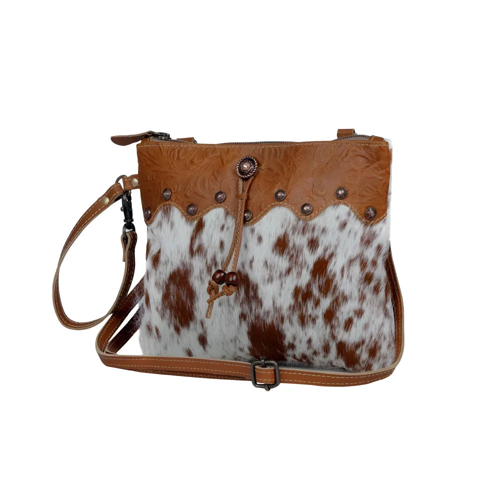 Ornate brown leather hairon bag with cowhide, studs and buckle