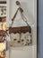 Ornate brown leather hairon bag with cowhide crossbody