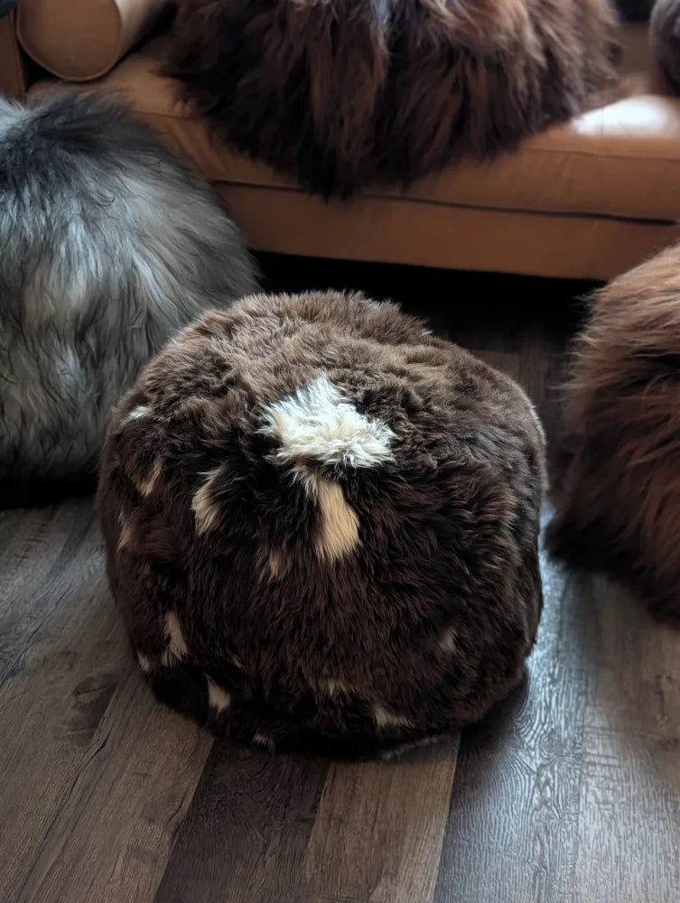 Natural British Angus Oliver brown sheepskin floor pouf with white tan patch