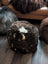 Natural British Angus Oliver brown sheepskin floor pouf with white tan patch