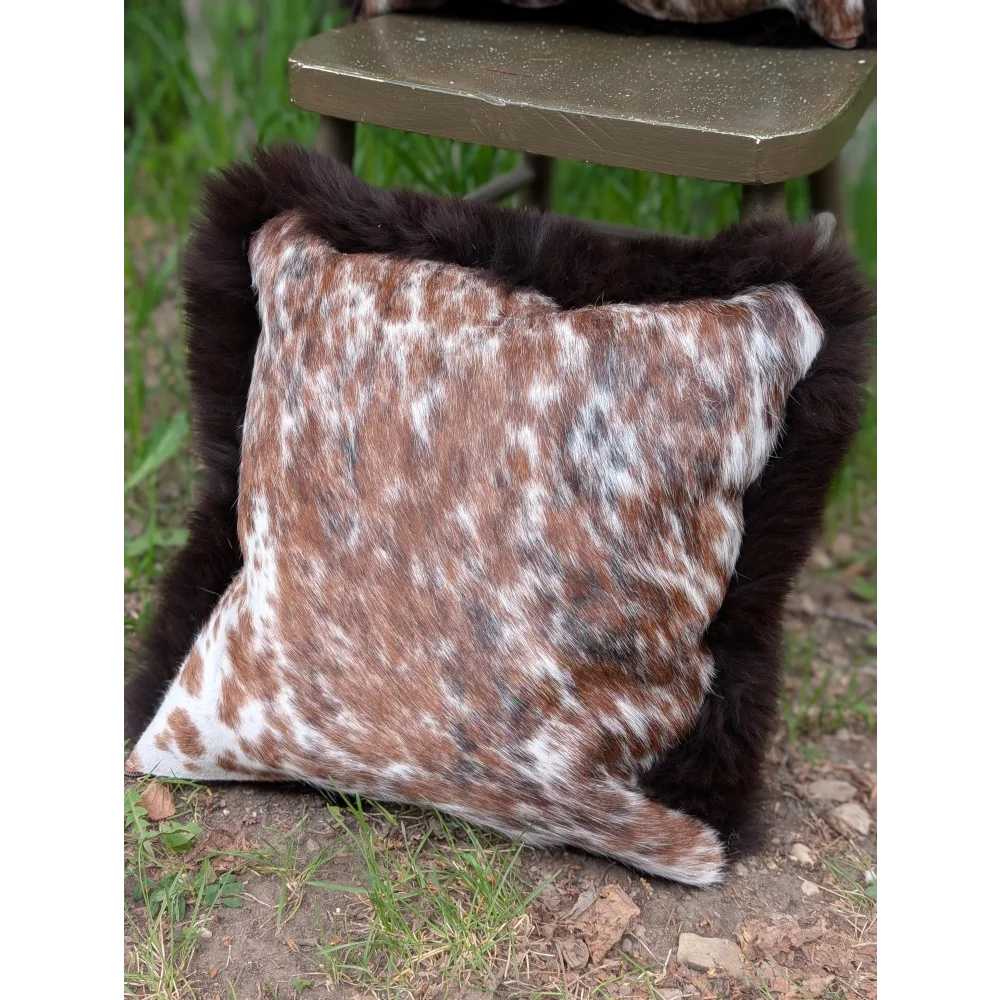 Pair of handmade brown and white spotted brazilian cowhide cushions with plush dark brown fur trim perfect for cozy decor