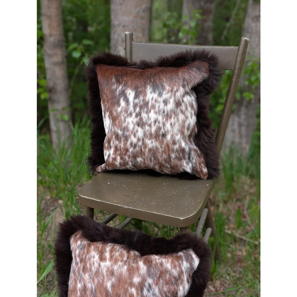 Brown and white spotted brazilian cowhide cushions with dark brown fur trim perfect for cozy home decor