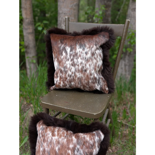 Brown and white spotted brazilian cowhide cushions with dark brown fur trim perfect for cozy home decor