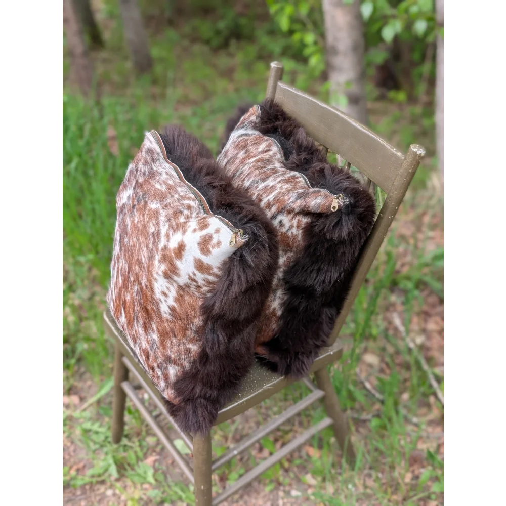 Pair of handmade british sheepskin and brazilian cowhide cushions with brown white cowhide and plush black fur trim
