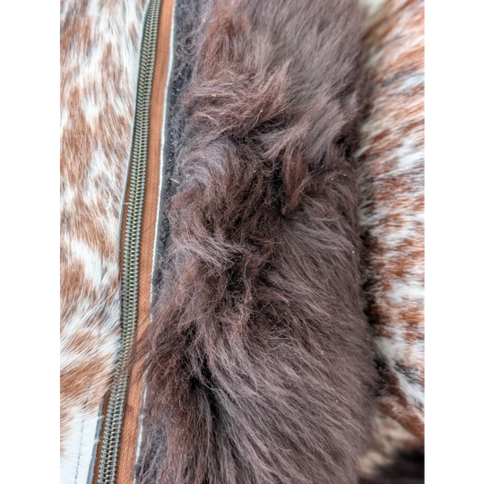 Close up of brown faux fur trim along the zipper of a cowhide jacket on british sheepskin cowhide cushions