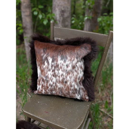 Brown and white cowhide cushions with dark brown fur trim handmade from british sheepskin for cozy decor