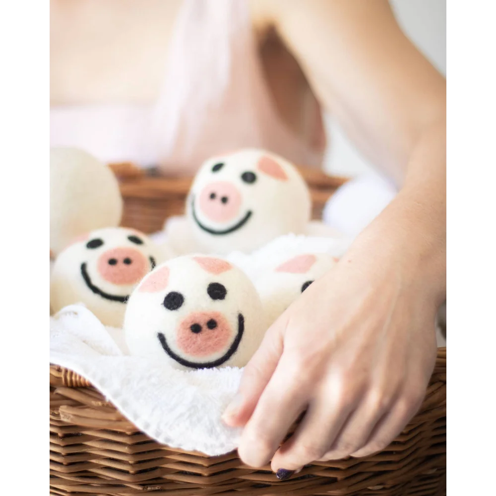 Cute pig trio eco dryer balls in basket with pink icing buns