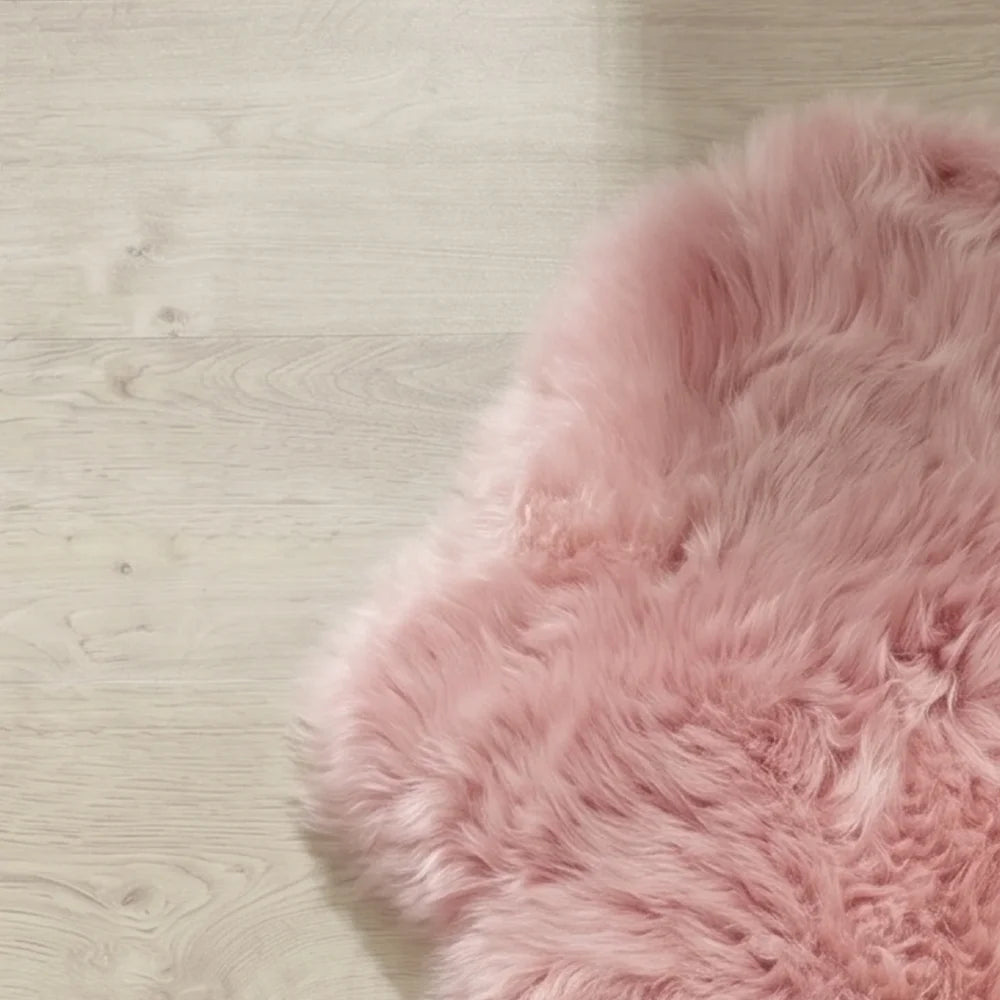 A soft fluffy pink merino sheepskin rug with natural curly texture made from strict european dyed merino sheepskins