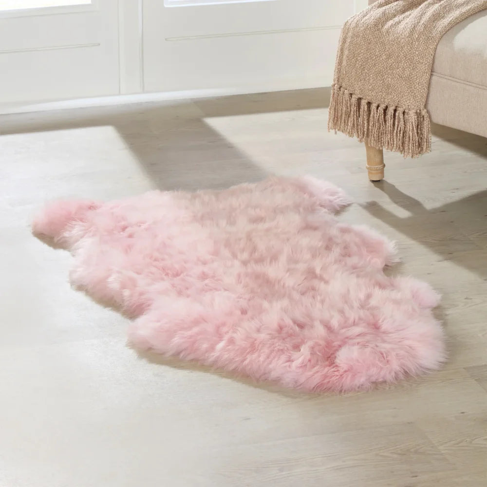 A soft fluffy pink dyed merino sheepskin rug with a natural shape meeting strict european standards arriving mid october