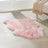A soft fluffy pink dyed merino sheepskin rug with a natural shape meeting strict european standards arriving mid october