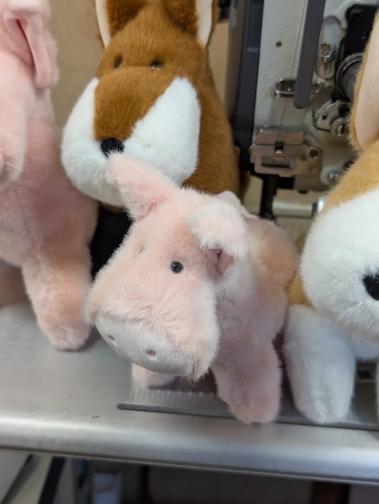 Soft pink plush pig with black button eyes and a stitched nose from pink piggies product line