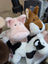 Pink piggies plush pig with soft fur and embroidered eyes next to brown fox and black and white cow stuffed animals