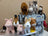 A gray industrial techsew sewing machine with plush pink piggies stuffed animals arranged around it