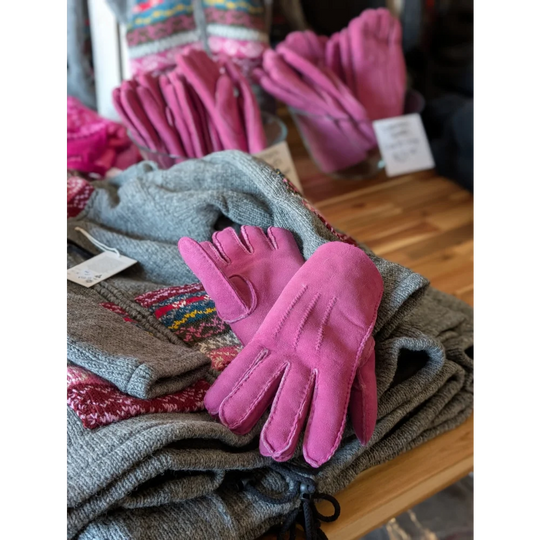 Ten pairs of brilliant shade pink sheepskin gloves with black drawstring