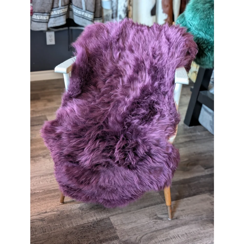 Gorgeous Plum Purple Merino Sheepskin Throw Blanket with Wooden Legs and White Armrests