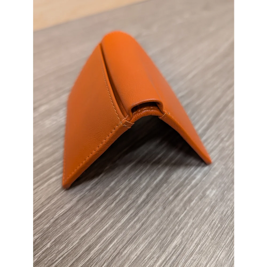 Sleek orange leather pocket card holder with minimalist design