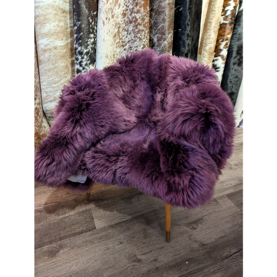 Purple sheepskin area rug 68x35in with wooden legs, soft texture