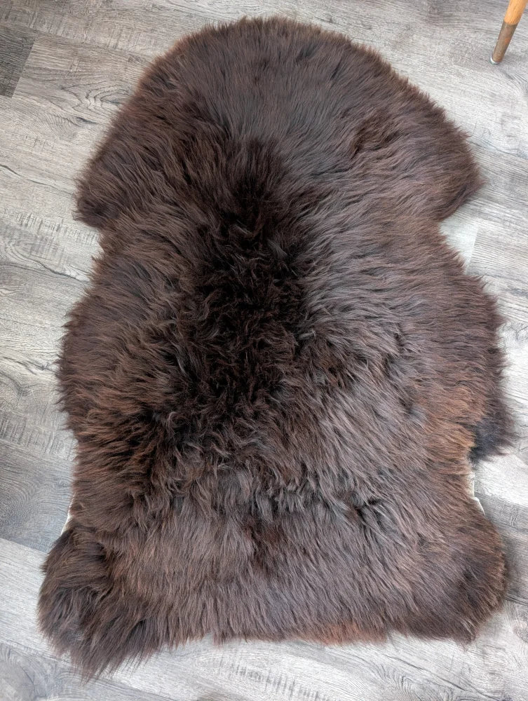 Rich dark brown british isles sheepskin rug with thick plush natural fur pile arriving soon