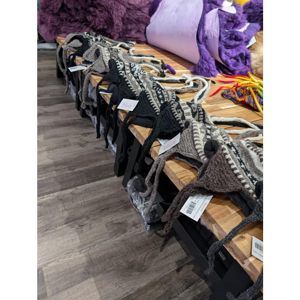 Medium black and white knitted dog sweaters with pom-poms, wool hats style