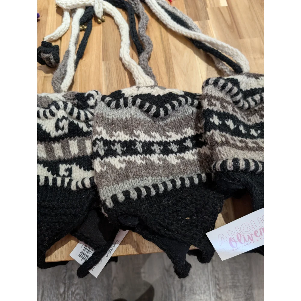 Black and white wool knit gloves with pom-poms for wool hats