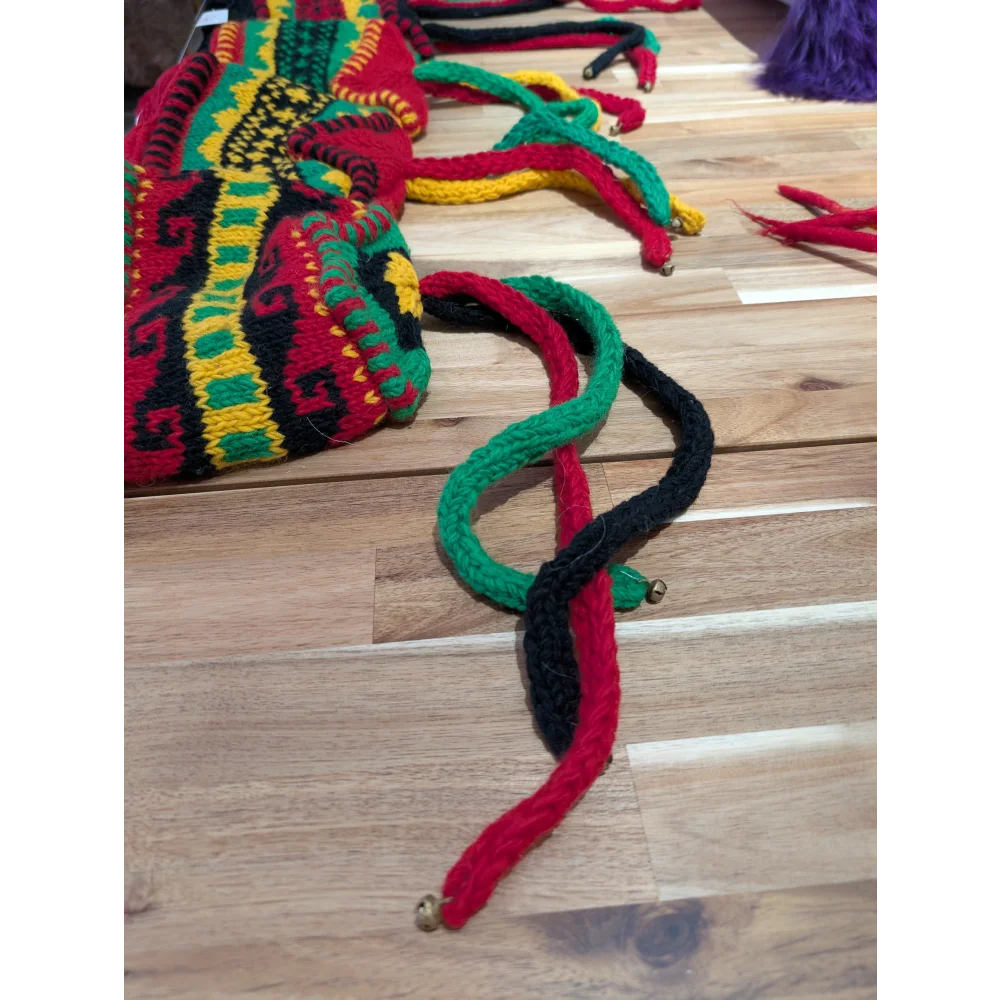 Multicolored woven wool hats bag with bell accents and patterns