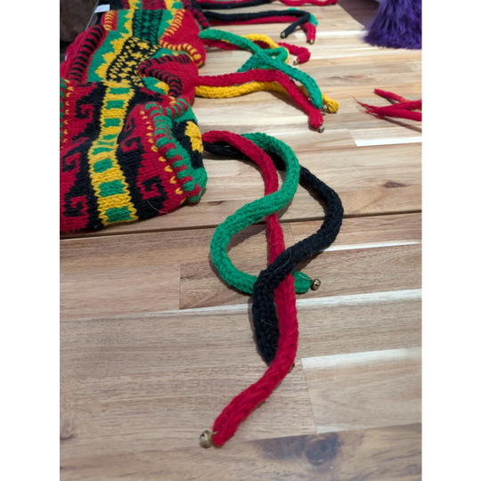 Multicolored woven wool hats bag with bell accents and patterns